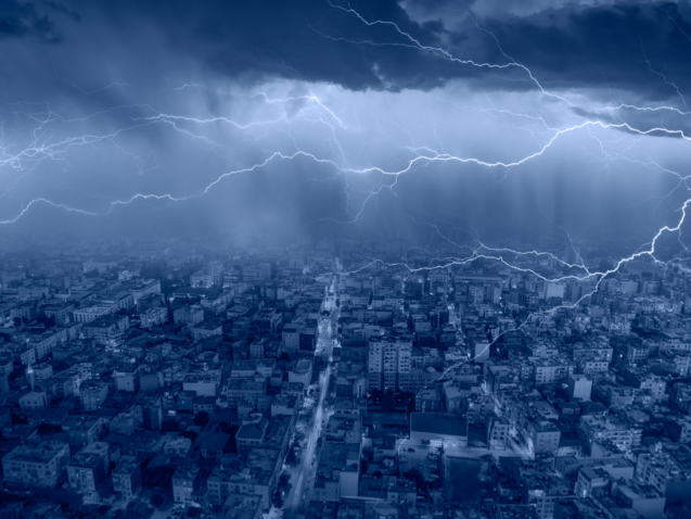 Lightning thunderstorm flash over the city at blue night sky - L