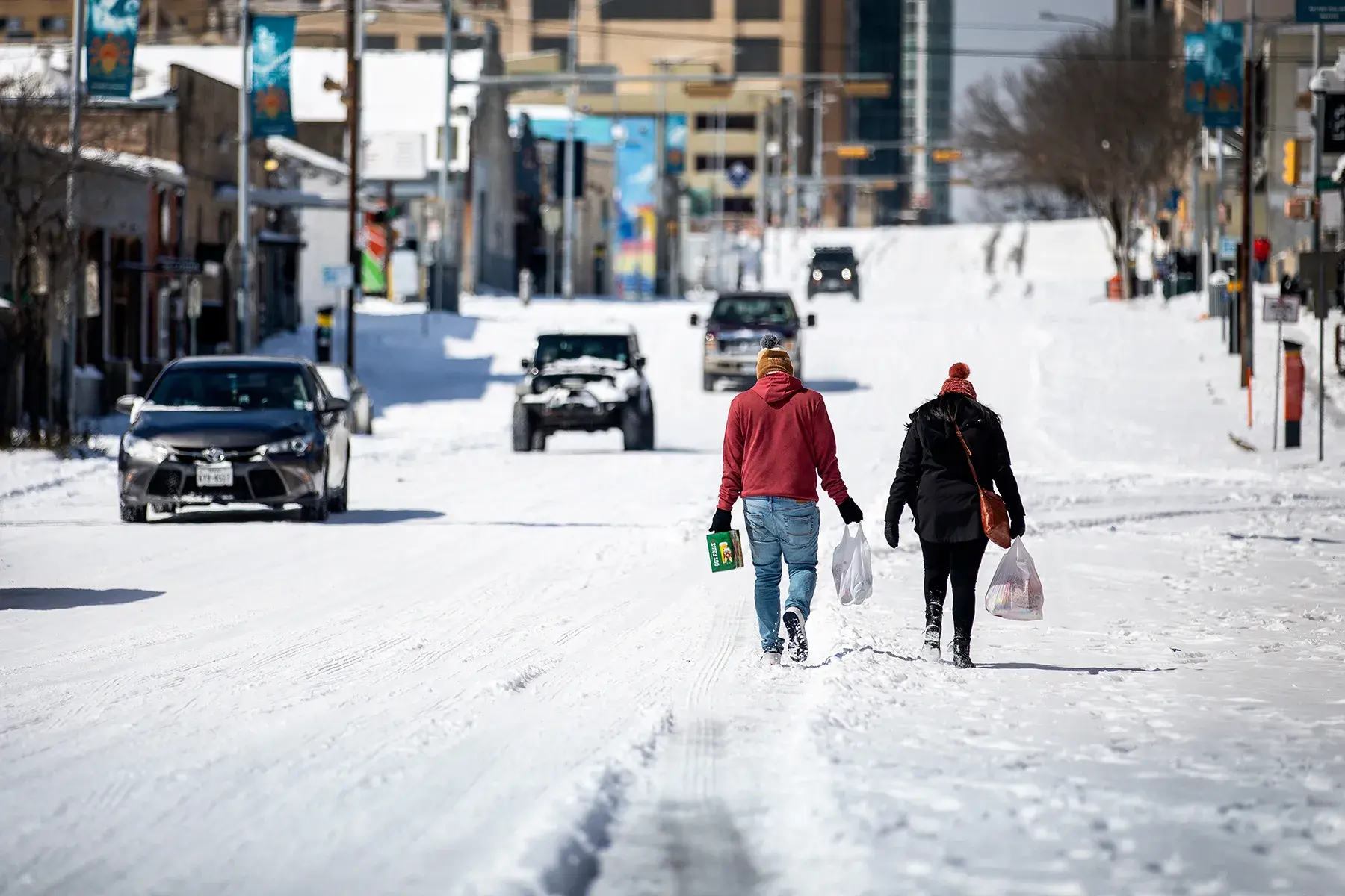 Icy Texas roadway with residents walking as LDR Site Services restores grocery operations.