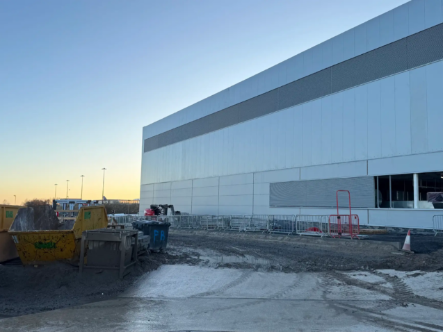 Dumpsters and containment barriers at retail location managed by LDR Site Services.