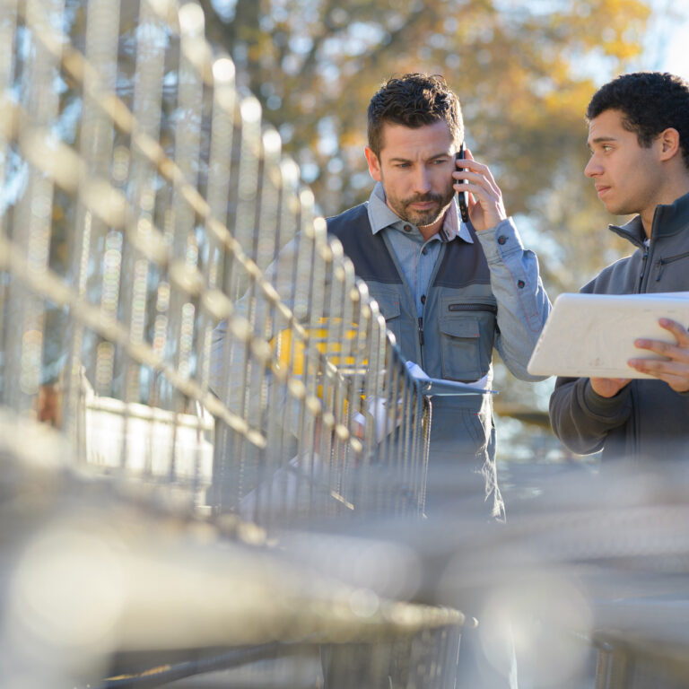 Workers setting up fence.