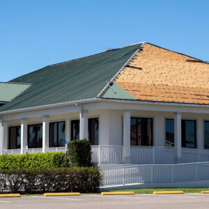 Natural disaster and its consequences. Hurricane Ian destroyed house roof in Florida residential area.