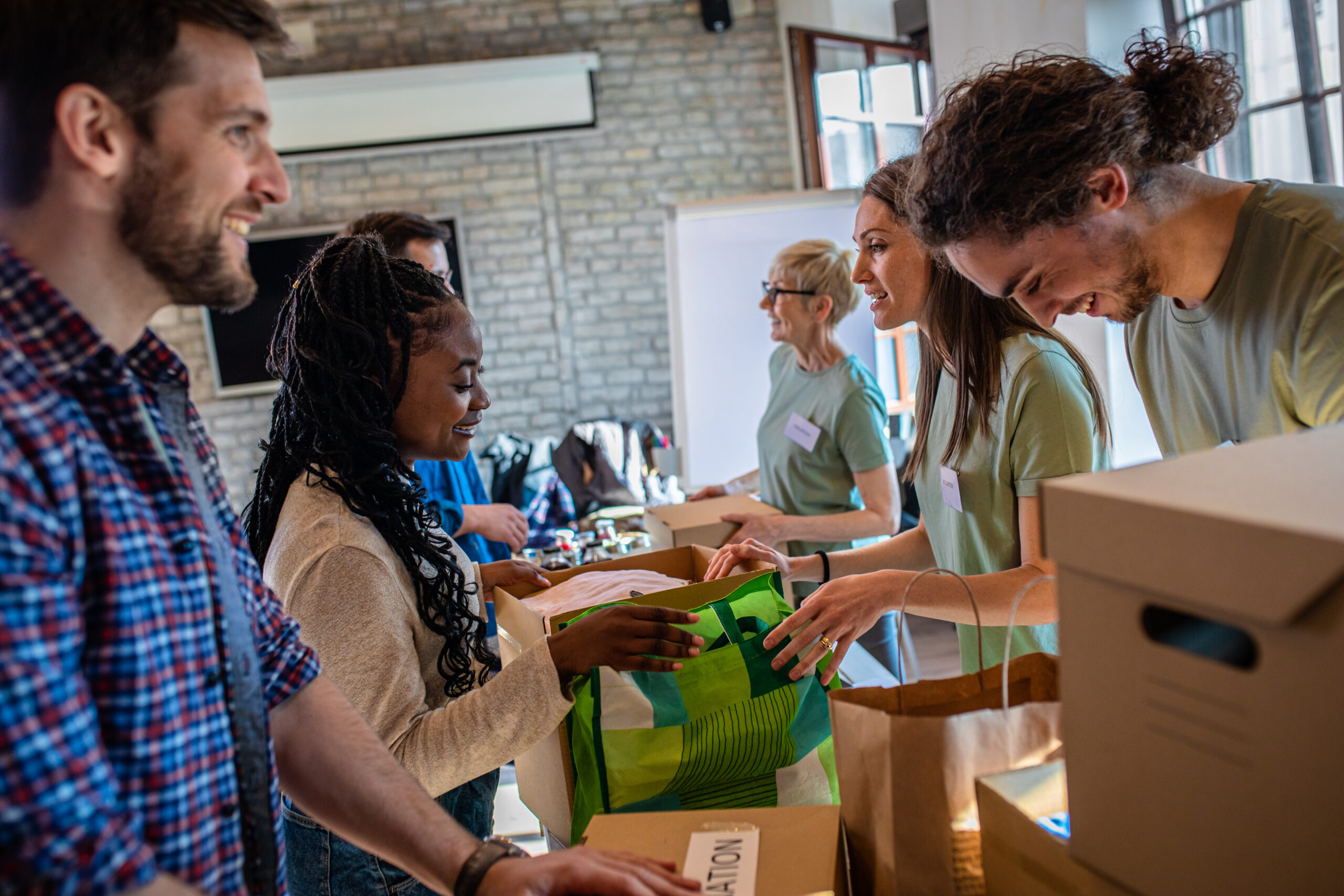 Volunteers and staff distributing donated food, water, and supplies to local residents during emergency relief response