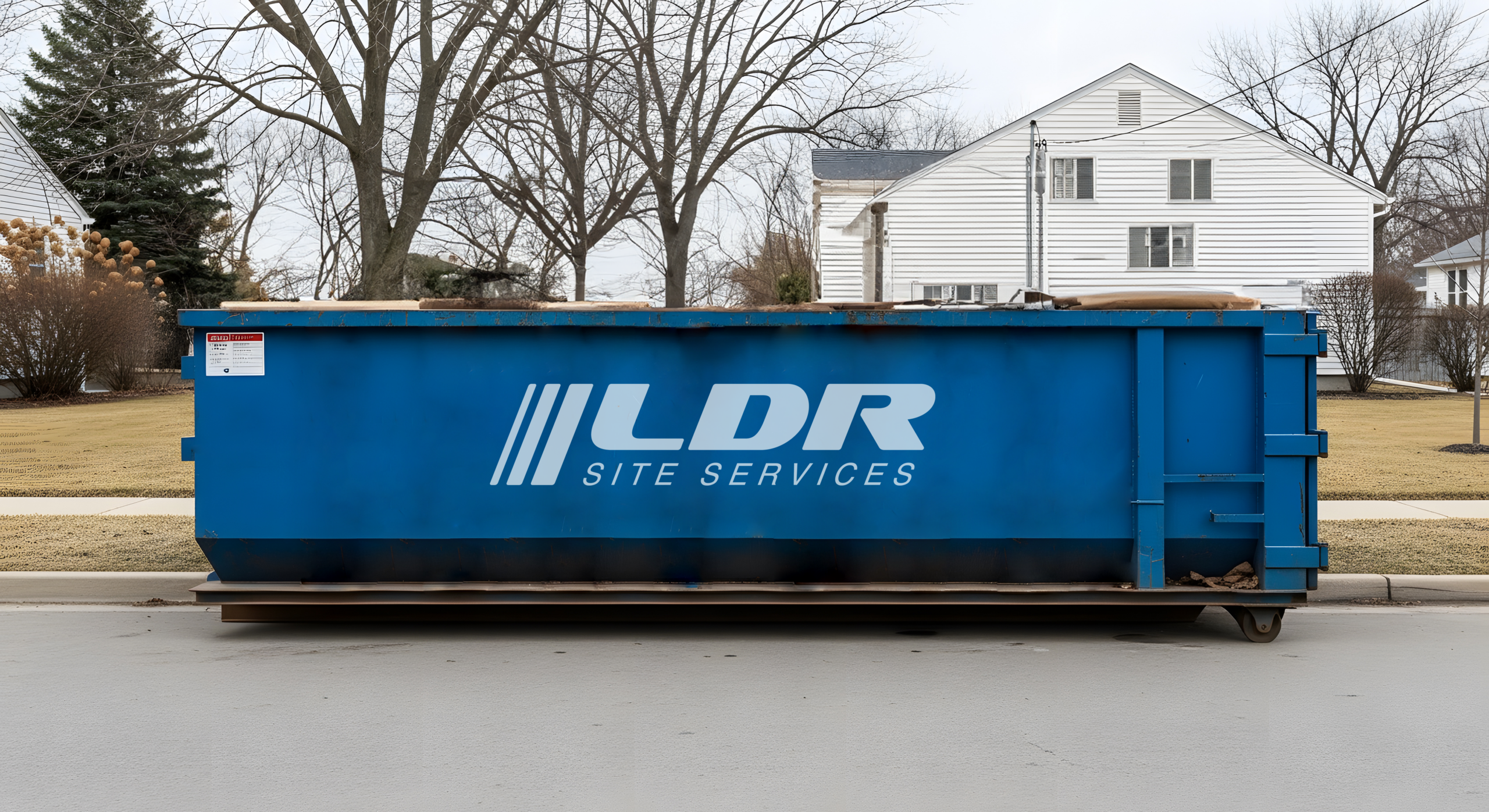 A roll-off dumpster staged at a commercial site