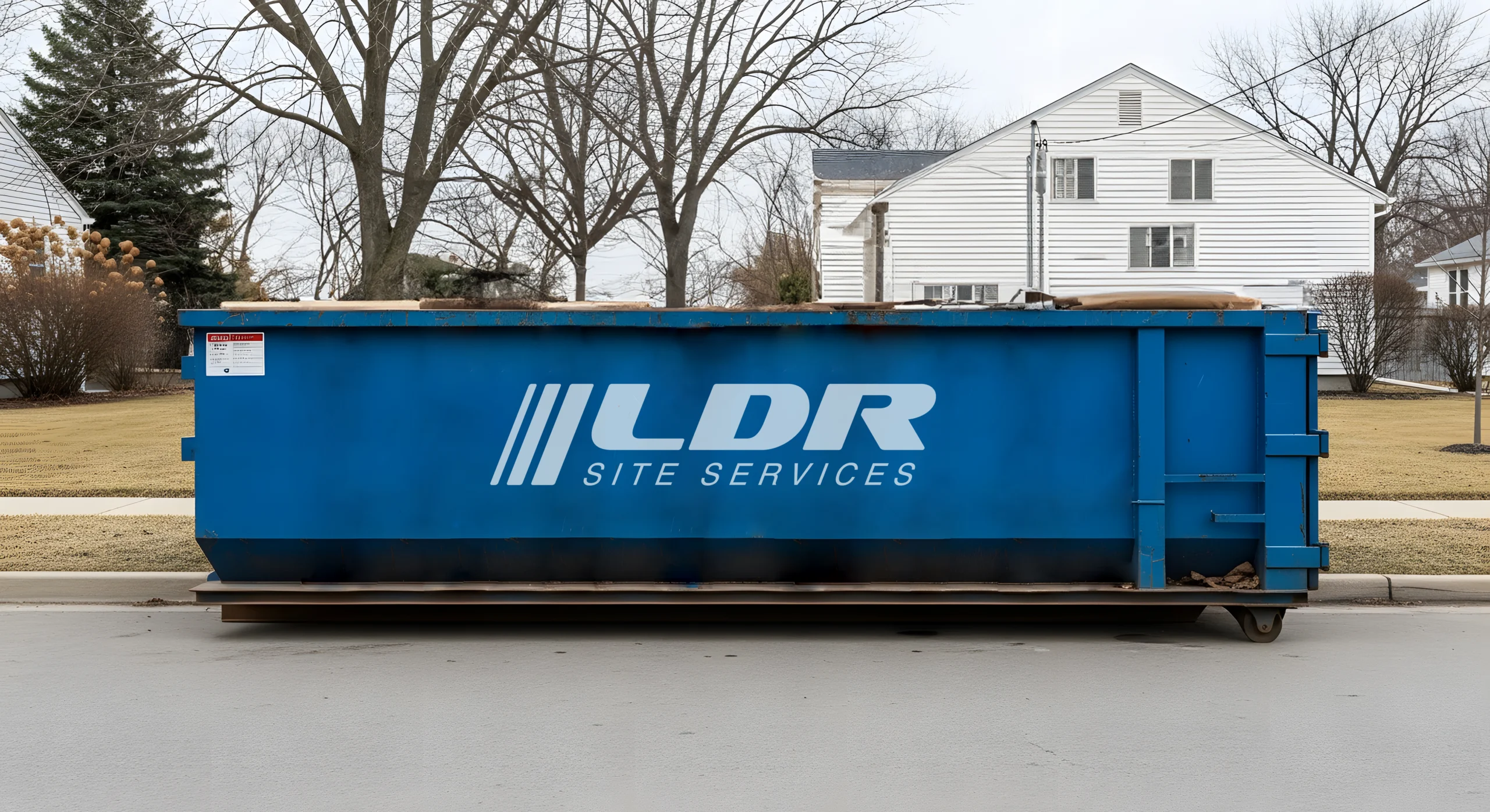 A roll-off dumpster staged at a commercial site