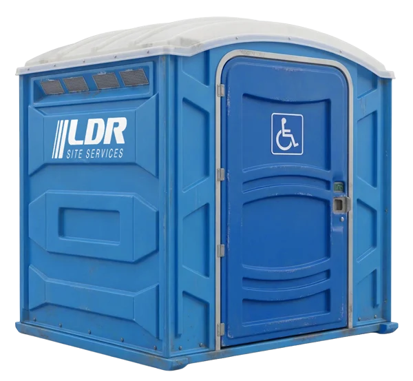 A wide ADA-accessible portable restroom with a wheelchair-accessibility placard