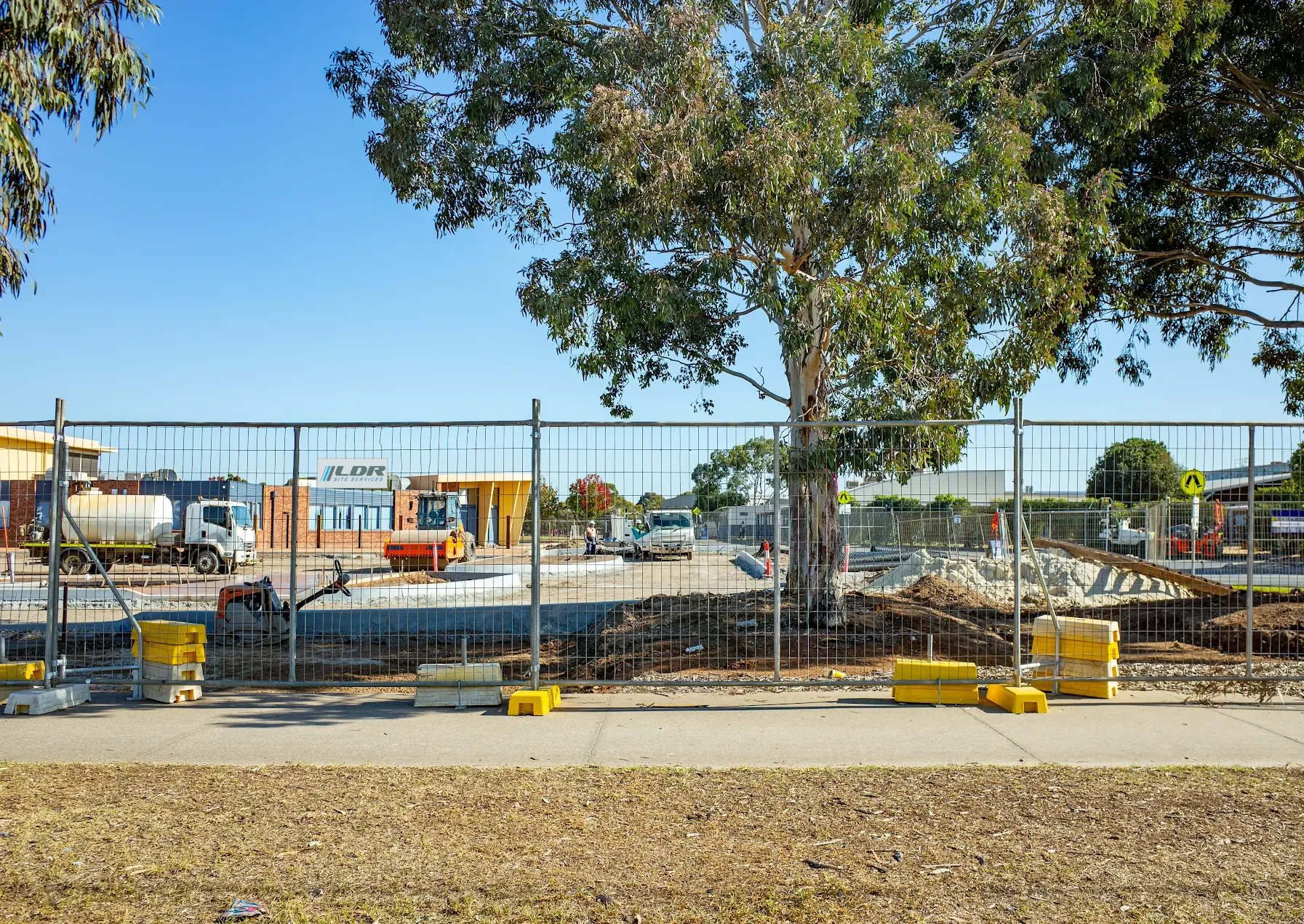 LDR Site Services temporary fencing secured around an active commercial construction site